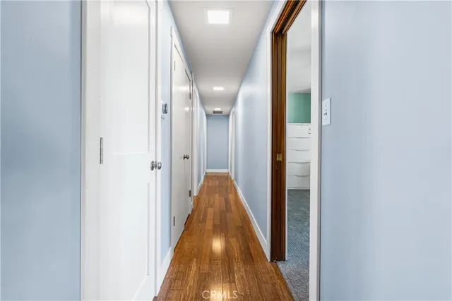 a view of hallway with wooden floor