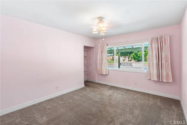 an empty room with windows and outdoor view