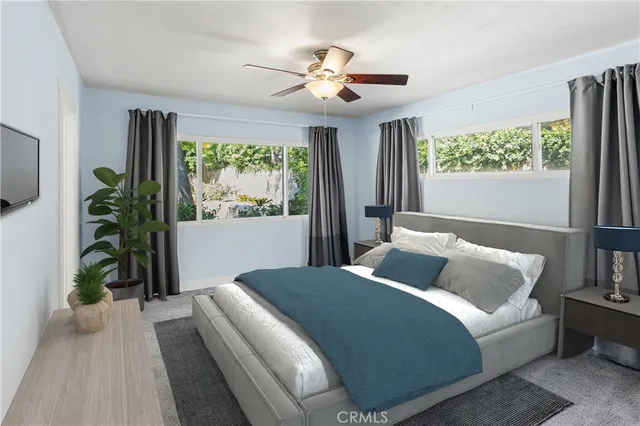 a bedroom with a large bed and a large window