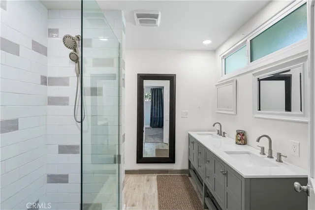 a bathroom with a double vanity sink and a mirror