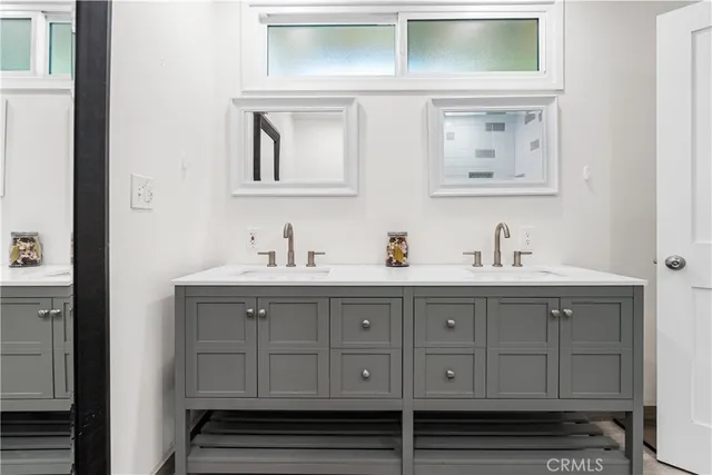 a bathroom with mirror and sink