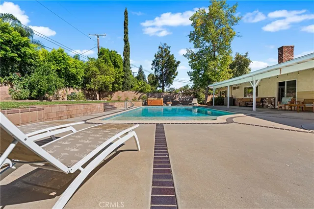 a view of a patio with a table and chairs