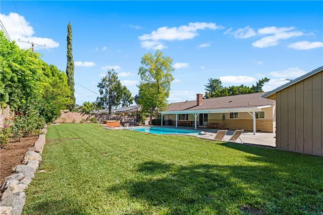 a view of a house with a yard porch and sitting area