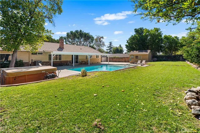 a view of a house with a backyard and a patio