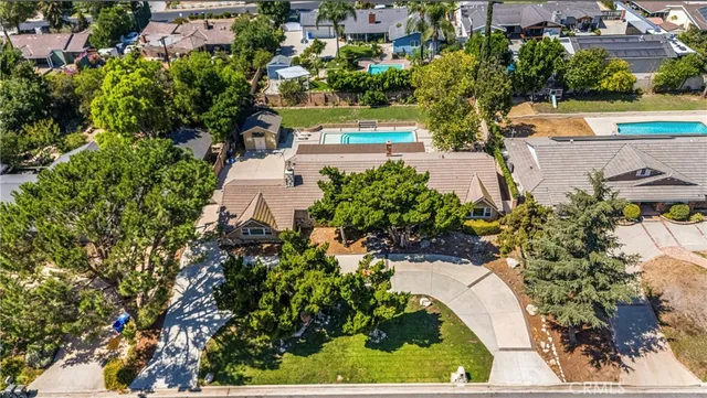 an aerial view of a house with a yard and lake view