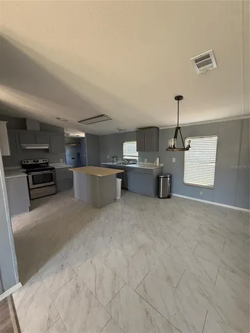 a large kitchen with a stove and cabinets
