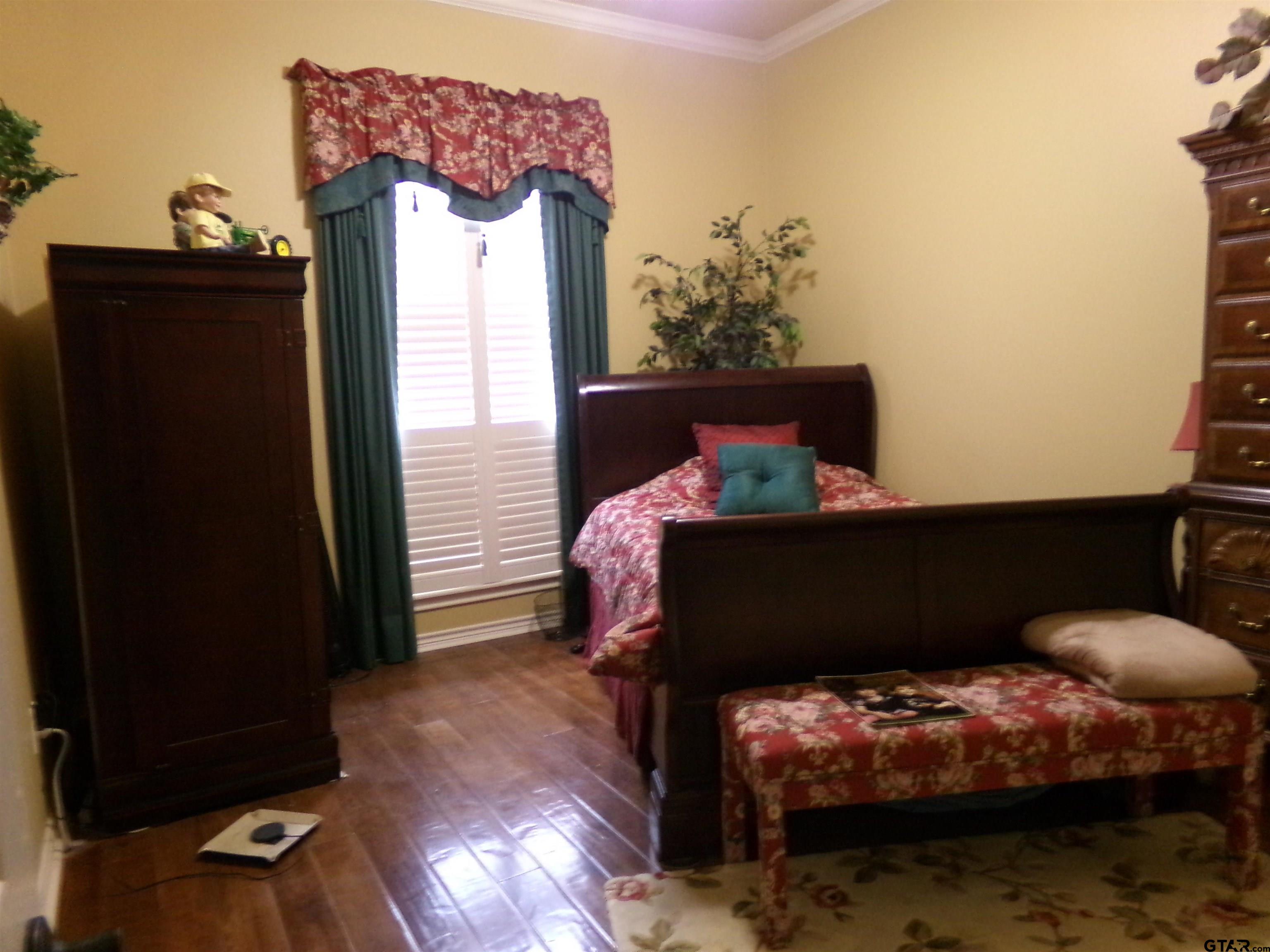 2425 Dietz Lane Tyler, TX 75701 - Photo 13 of 18 a bedroom with a bed and a window