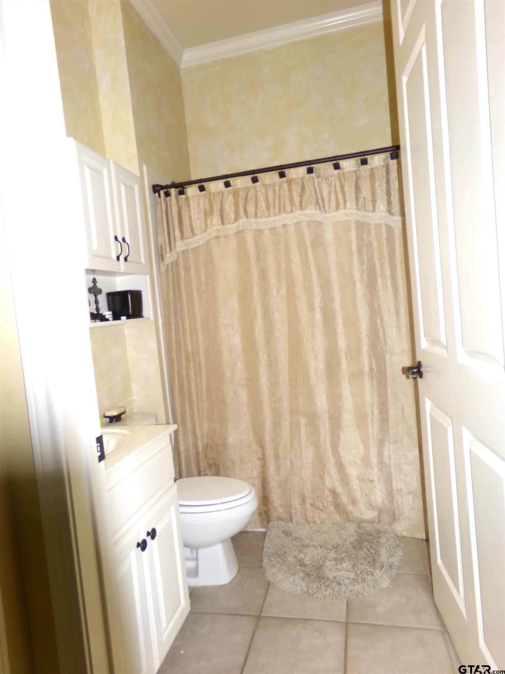 2425 Dietz Lane Tyler, TX 75701 - Photo 14 of 18 a bathroom with a toilet and a shower
