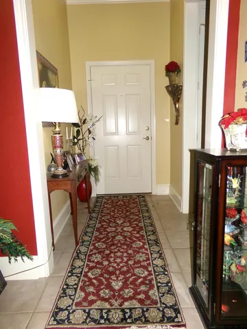 view of a hallway with wooden floor and a living room