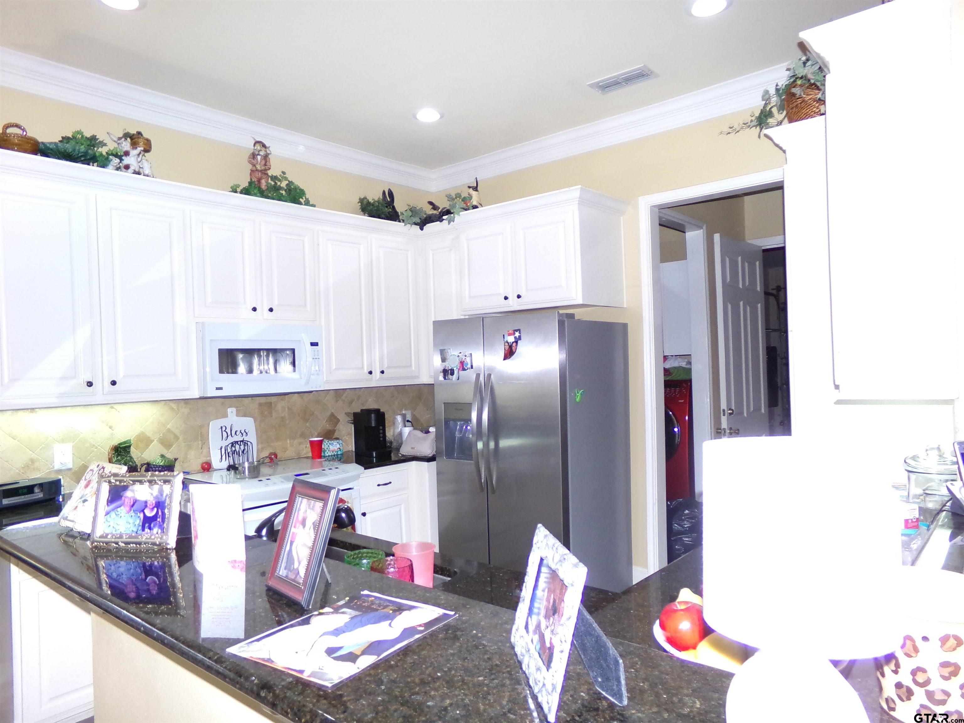 2425 Dietz Lane Tyler, TX 75701 - Photo 7 of 18 a kitchen with refrigerator and cabinets