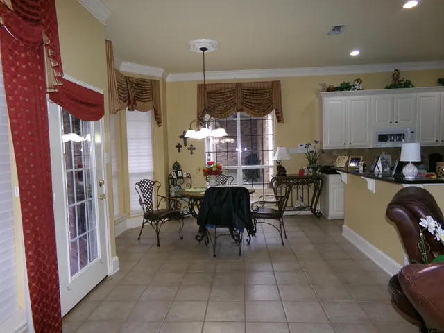 a living room with lots of furniture and a large window