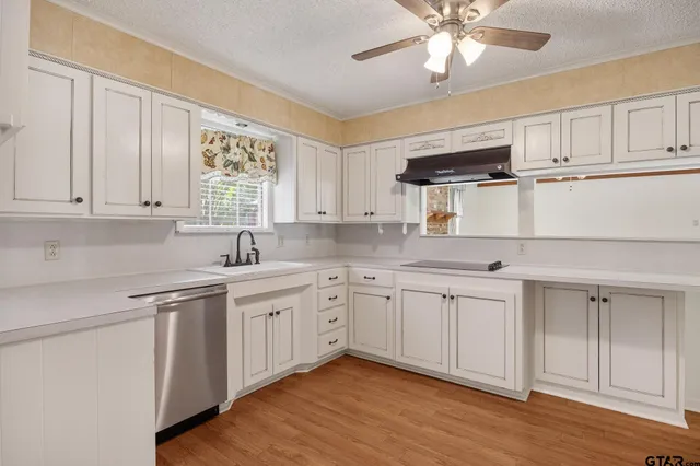 a kitchen with cabinets a sink and appliances