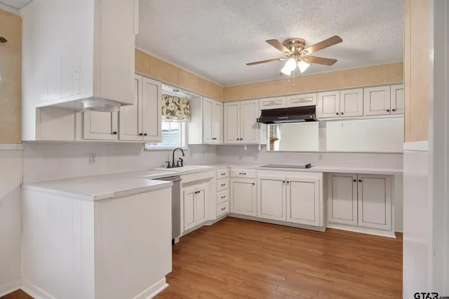 a kitchen with a sink cabinets and window