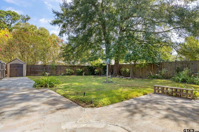 a front view of a house with a garden and patio