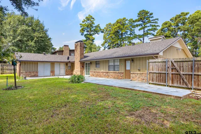 a backyard of a house with table and chairs