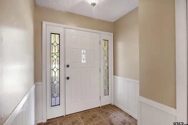 a view of bathroom with a sink and mirror