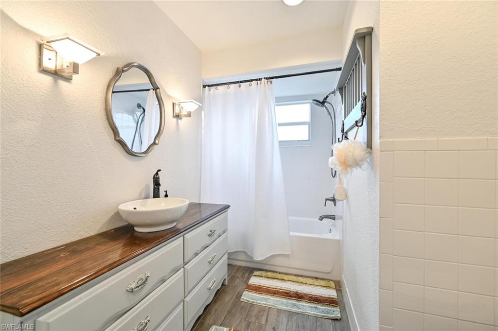 3131 Calusa Avenue Naples, FL 34112 - Photo 11 of 26 a bathroom with a sink and a mirror