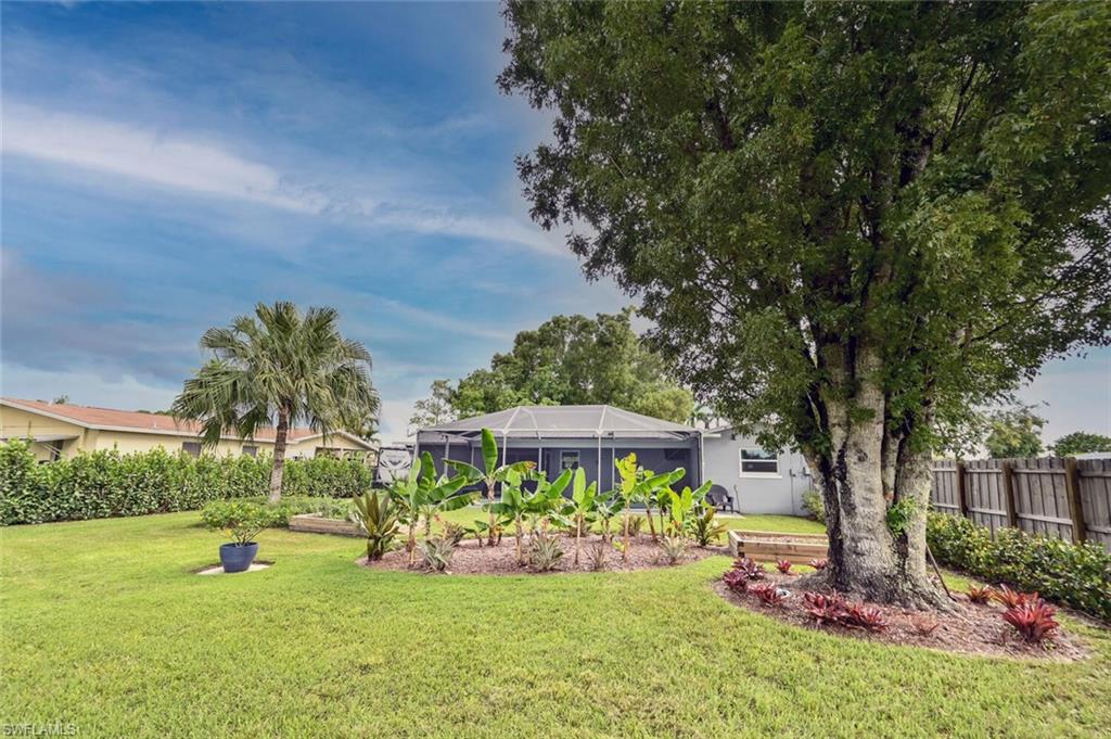 3131 Calusa Avenue Naples, FL 34112 - Photo 14 of 26 a view of a house with garden yard and sitting area