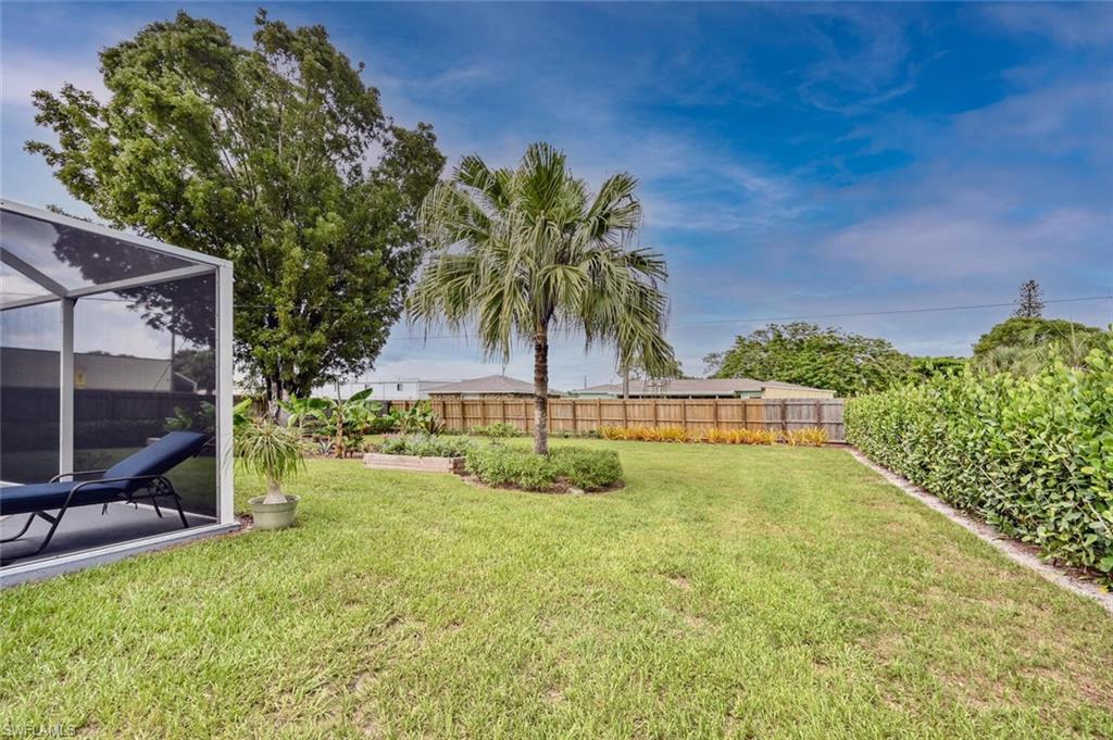 3131 Calusa Avenue Naples, FL 34112 - Photo 16 of 26 a view of swimming pool with a yard