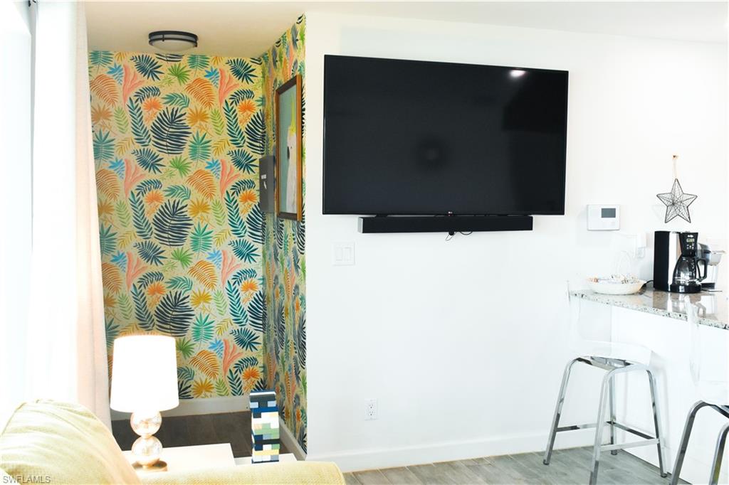 3131 Calusa Avenue Naples, FL 34112 - Photo 20 of 26 a living room with a couch and a flat screen tv