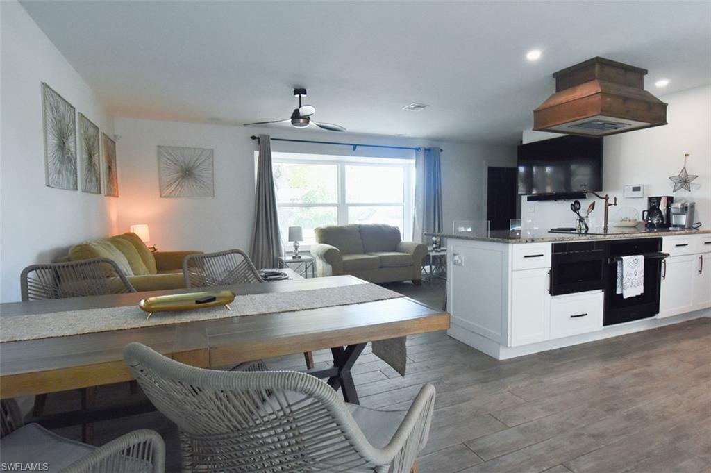 3131 Calusa Avenue Naples, FL 34112 - Photo 22 of 26 a living room with granite countertop furniture a dining table and chairs