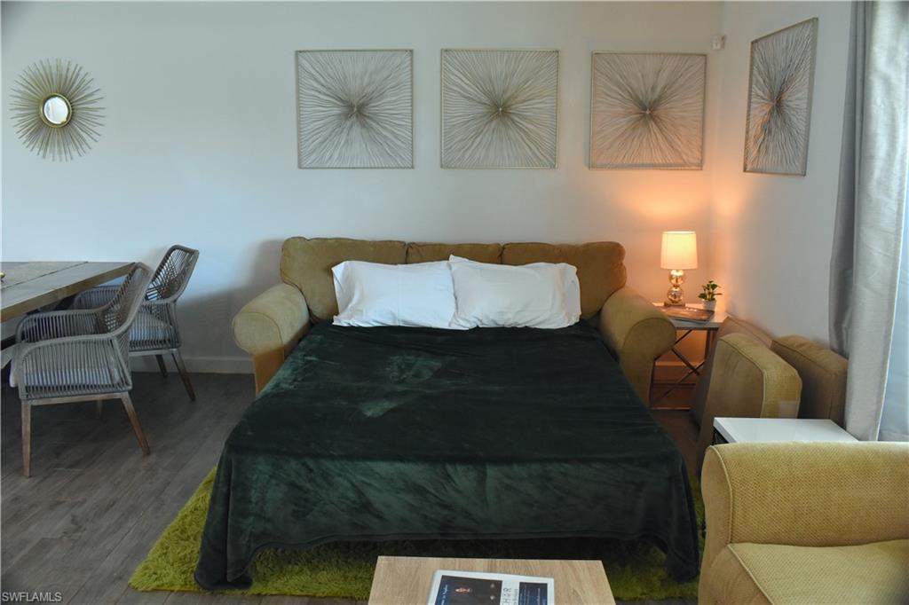 3131 Calusa Avenue Naples, FL 34112 - Photo 26 of 26 a bedroom with a bed and chair