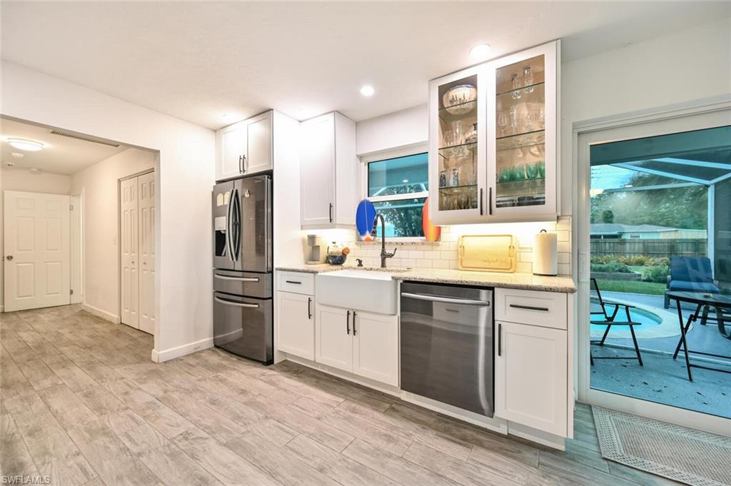 3131 Calusa Avenue Naples, FL 34112 - Photo 4 of 26 a kitchen with a refrigerator and a sink