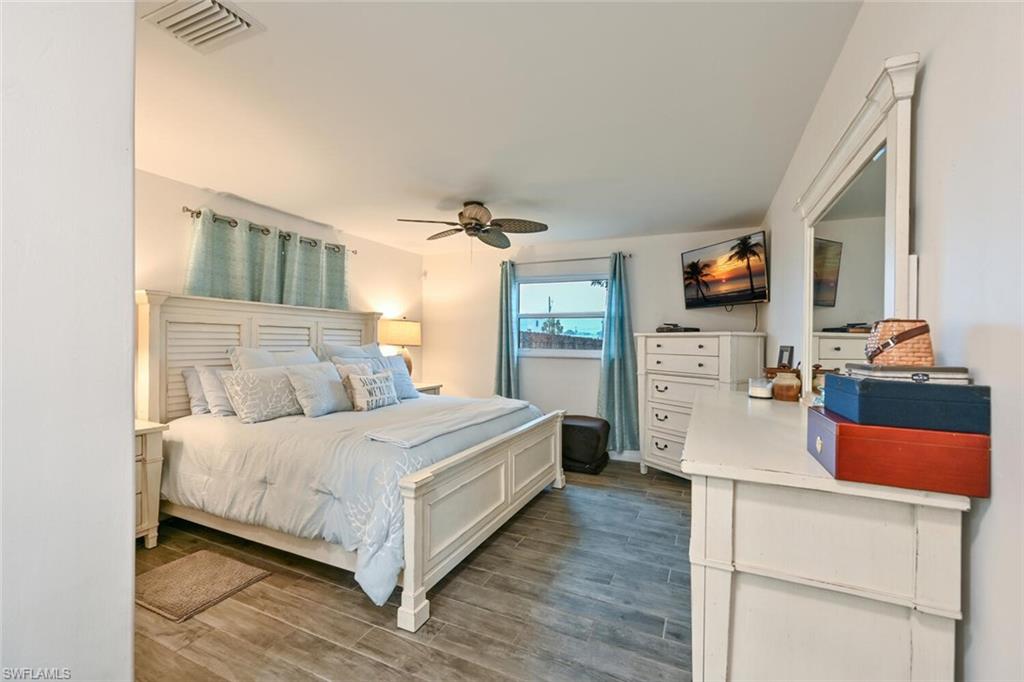 3131 Calusa Avenue Naples, FL 34112 - Photo 8 of 26 a bedroom with a bed and a flat screen tv