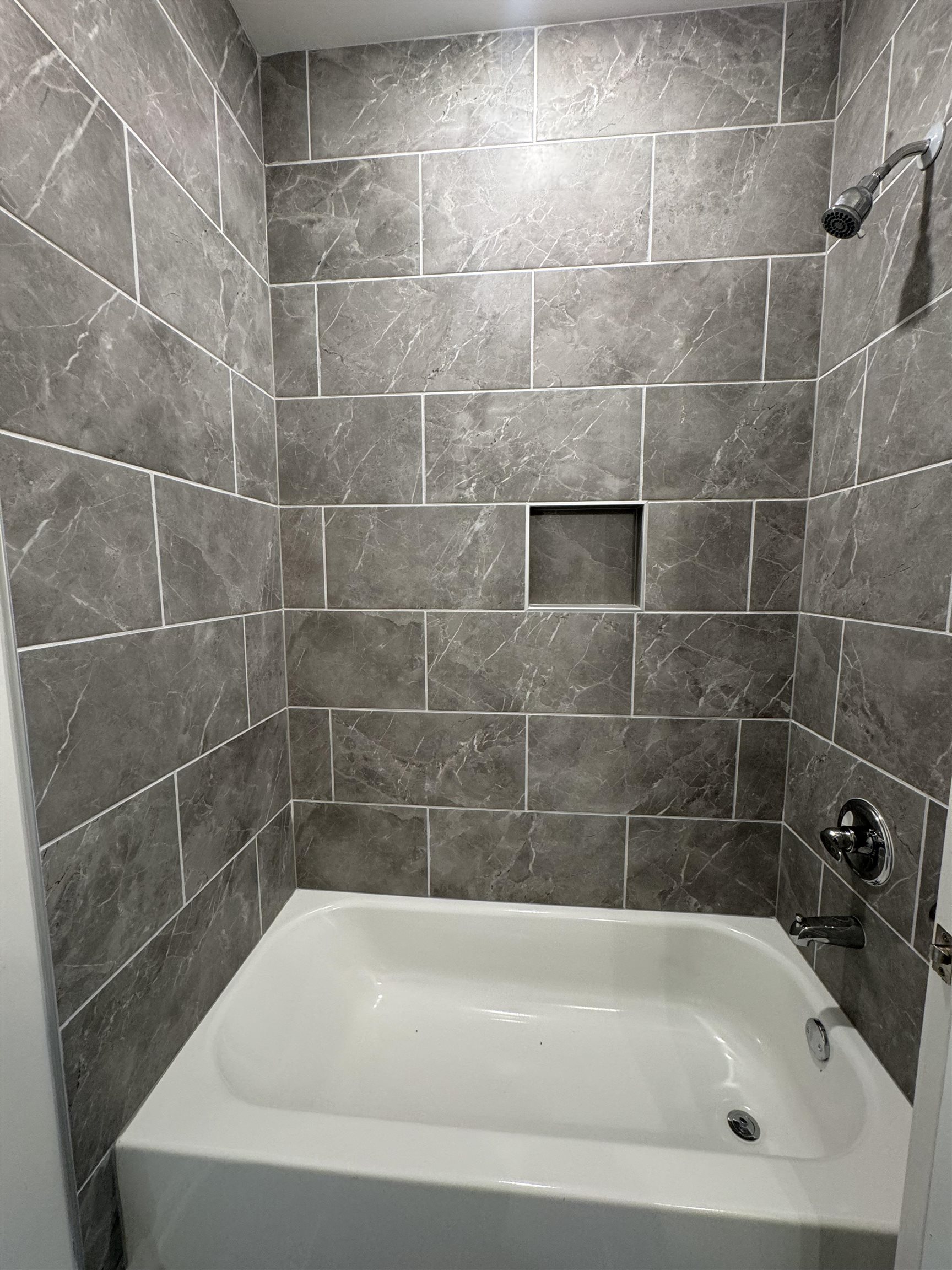 12370 South Main Street Somerville, TN 38068 - Photo 20 of 26 Bathtub and shower combination featuring gray marble-look subway tile