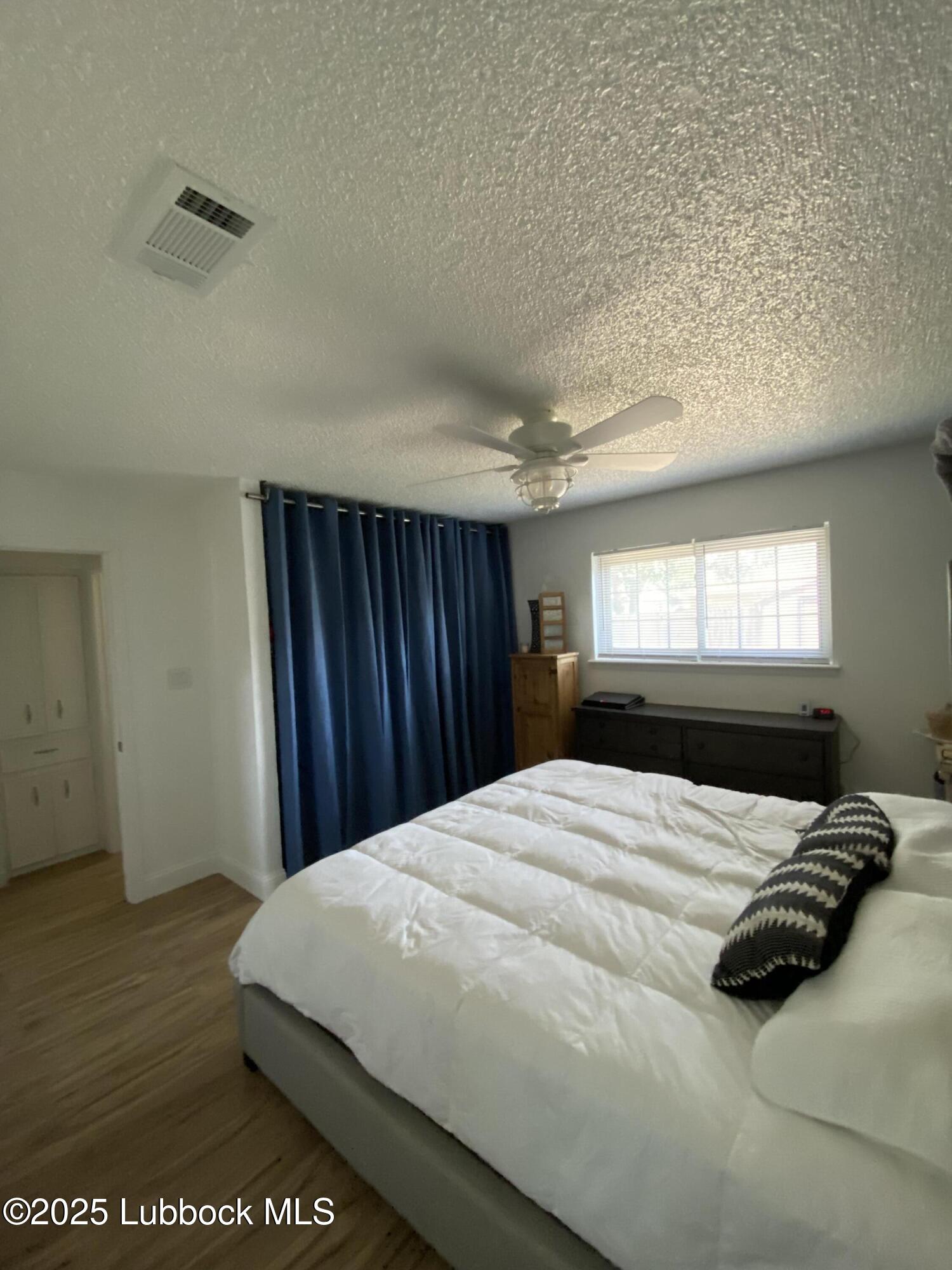 6403 28th Street Lubbock, TX 79407 - Photo 15 of 27 a bedroom with a bed and a window