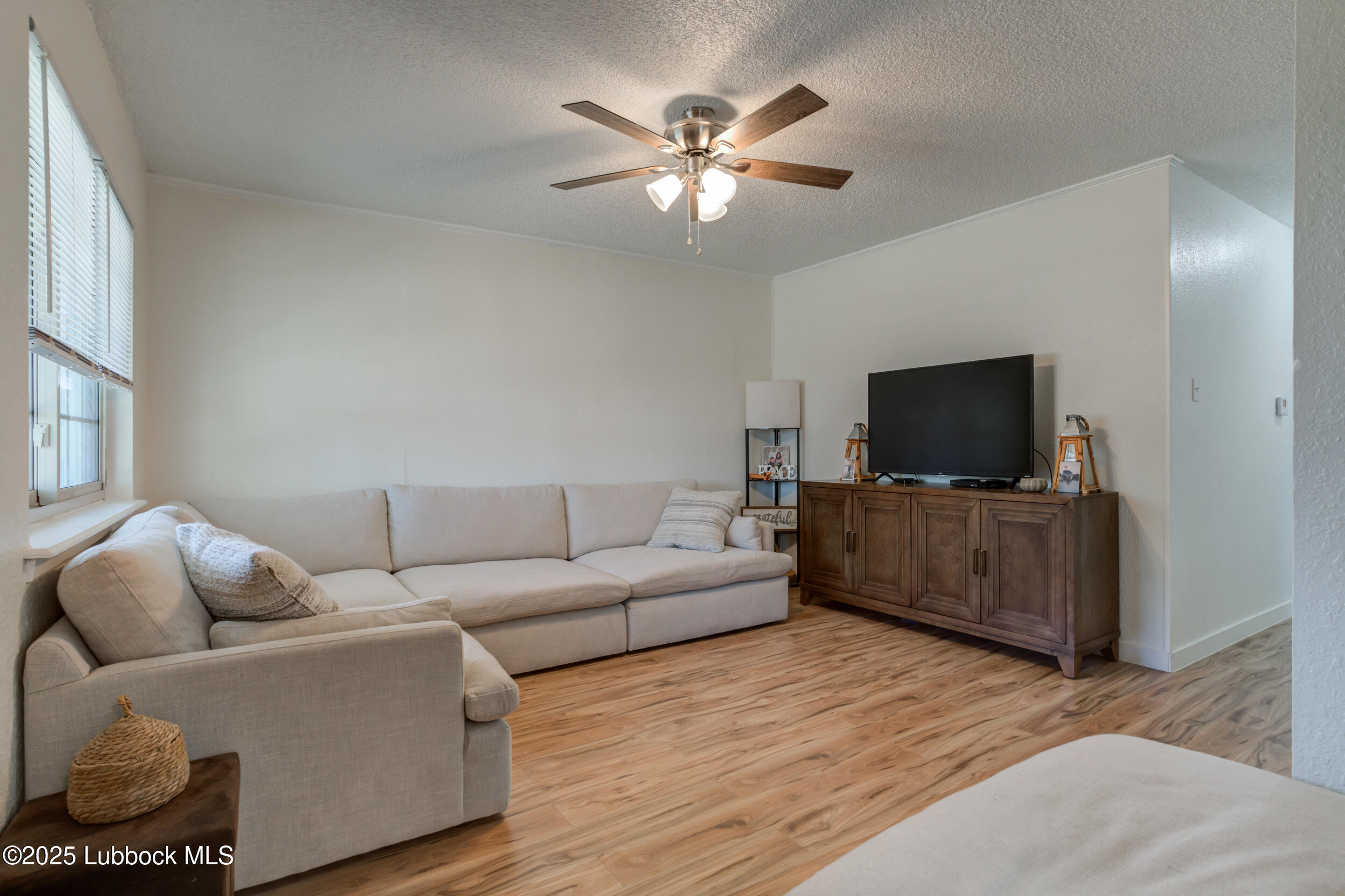 6403 28th Street Lubbock, TX 79407 - Photo 2 of 27 a living room with furniture and a flat screen tv