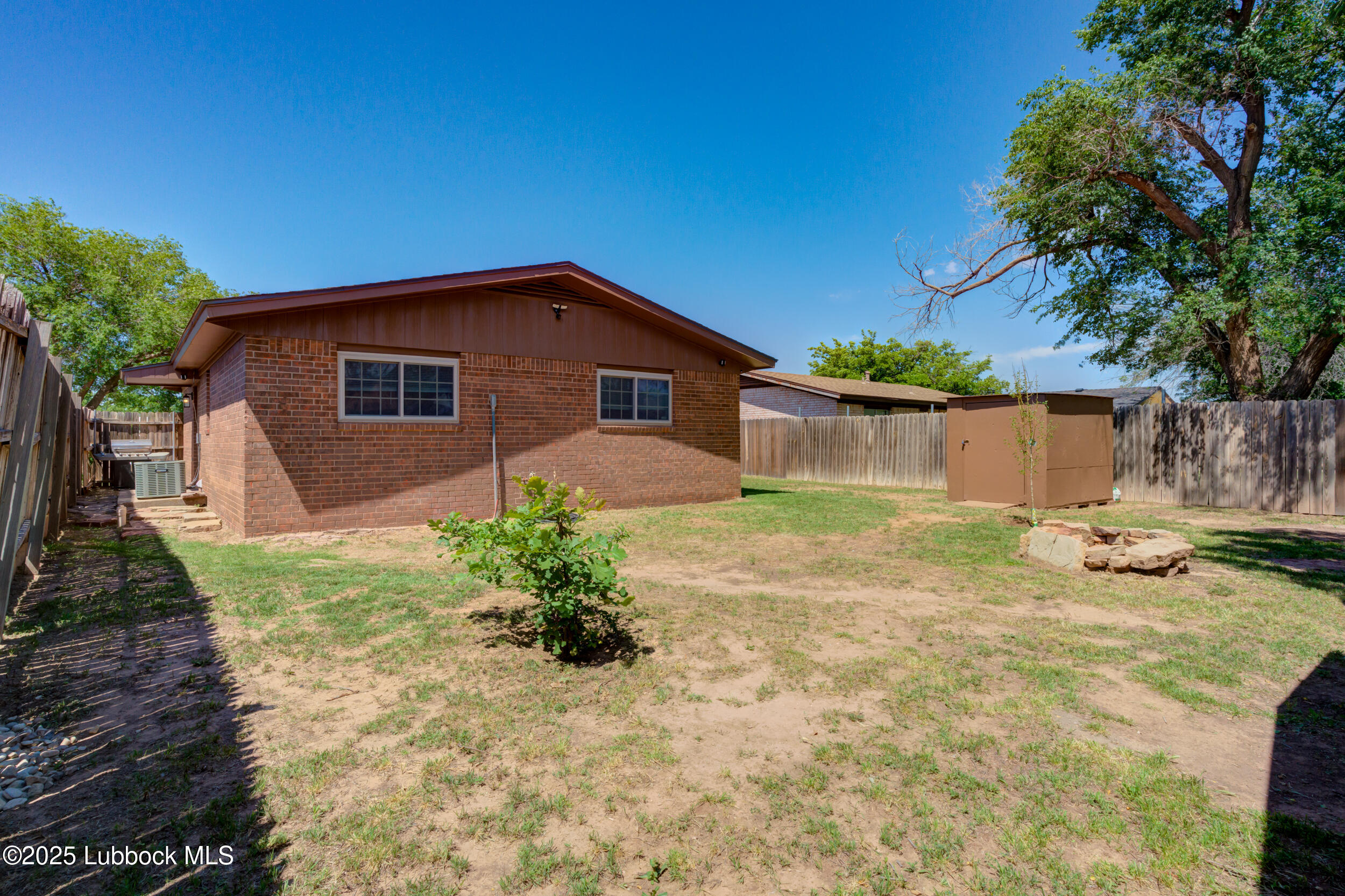 6403 28th Street Lubbock, TX 79407 - Photo 23 of 27 a front view of a house with a yard and garage