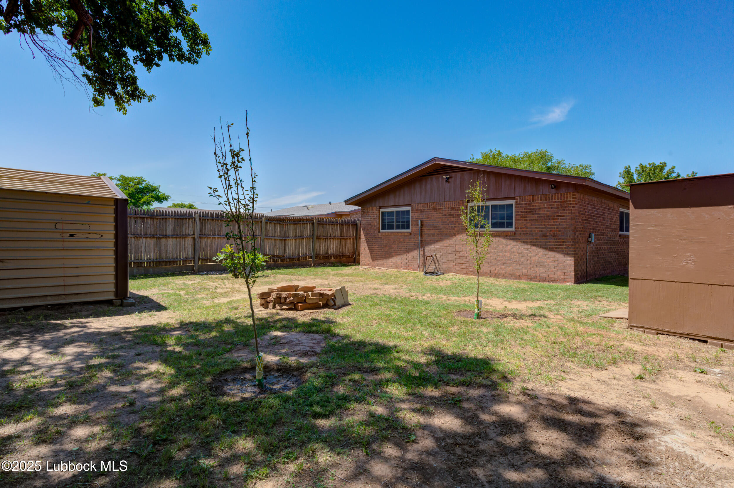 6403 28th Street Lubbock, TX 79407 - Photo 25 of 27 a backyard of a house with table and chairs