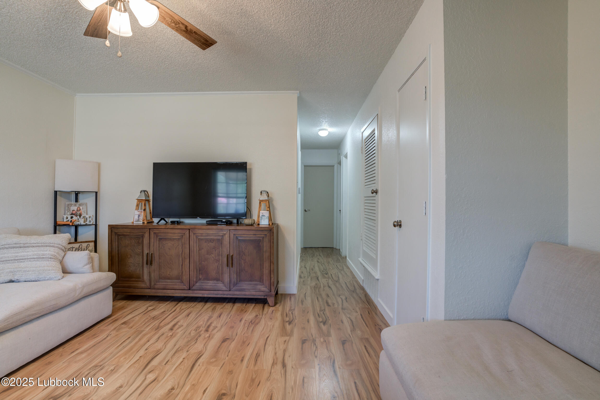 6403 28th Street Lubbock, TX 79407 - Photo 5 of 27 a living room with furniture and a flat screen tv