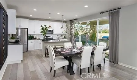 a dining room with furniture and a floor to ceiling window