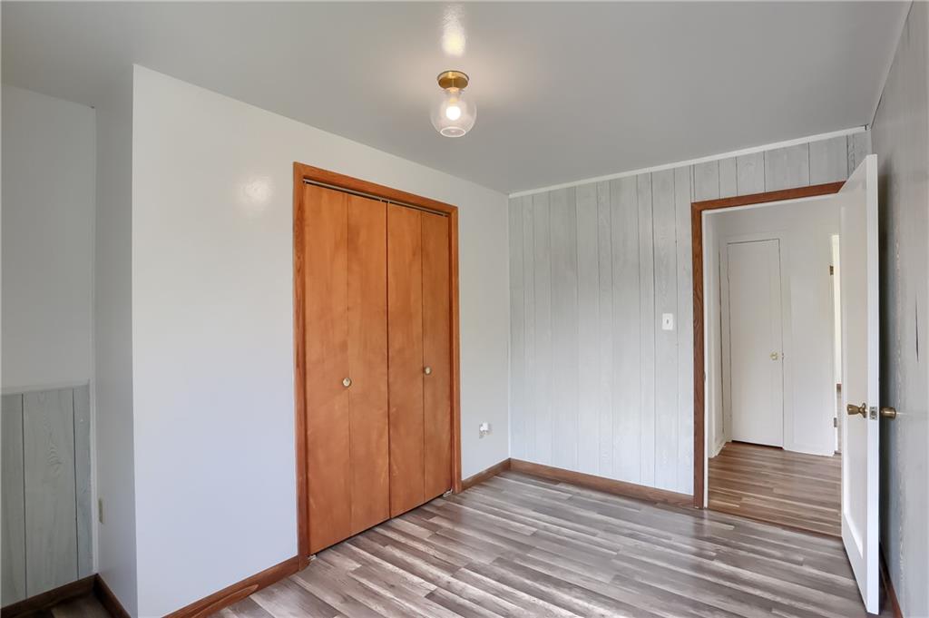 1081 Evans City Road Renfrew, PA 16053 - Photo 14 of 24 wooden floor in an empty room with a closet