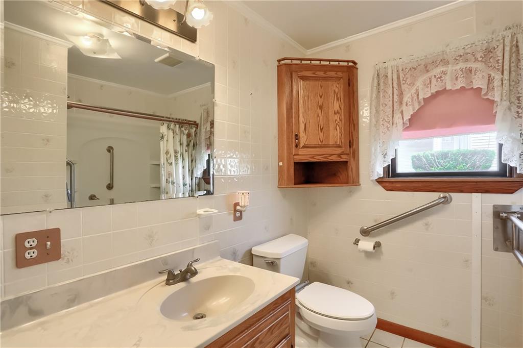 1081 Evans City Road Renfrew, PA 16053 - Photo 15 of 24 a bathroom with a sink vanity mirror and toilet