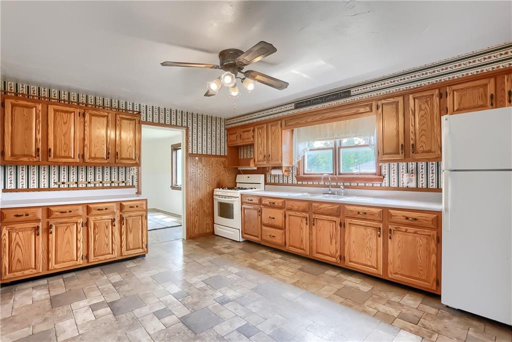 1081 Evans City Road Renfrew, PA 16053 - Photo 7 of 24 a large kitchen with granite countertop a large window a sink and stainless steel appliances