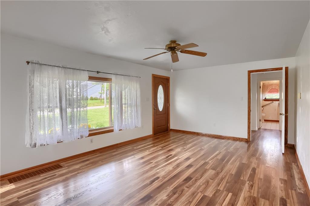 1081 Evans City Road Renfrew, PA 16053 - Photo 10 of 24 a view of empty room with wooden floor and fan