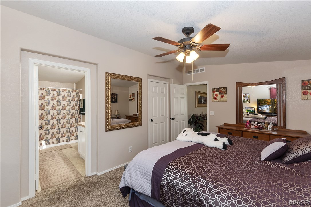 547 Alden Road, Unit 33 Big Bear Lake, CA 92315 - Photo 17 of 28 a bedroom with a bed and a chandelier
