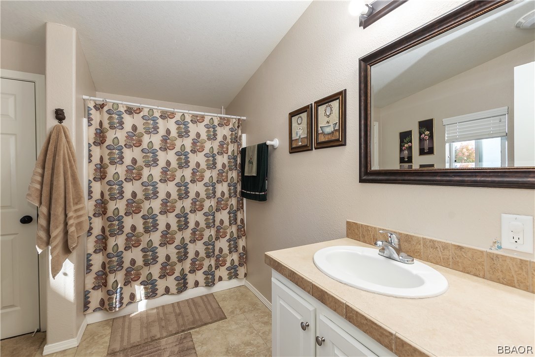 547 Alden Road, Unit 33 Big Bear Lake, CA 92315 - Photo 18 of 28 a bathroom with a sink and a mirror