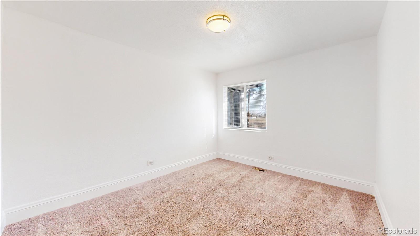 345 South Utica Street Denver, CO 80219 - Photo 12 of 19 an empty room with a window