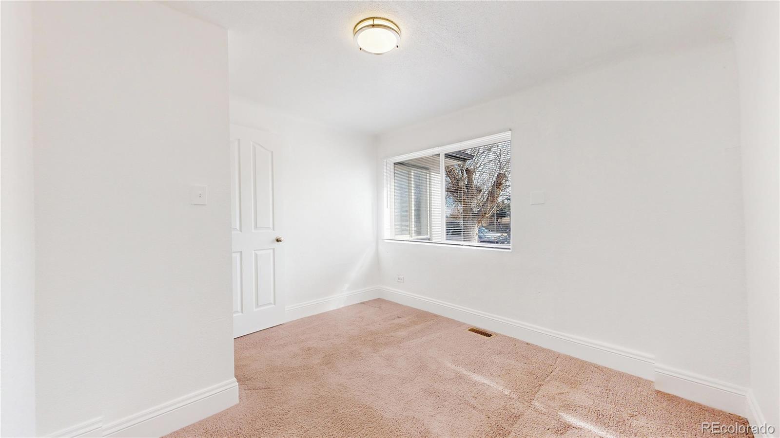 345 South Utica Street Denver, CO 80219 - Photo 14 of 19 a view of room with window and ceiling fan
