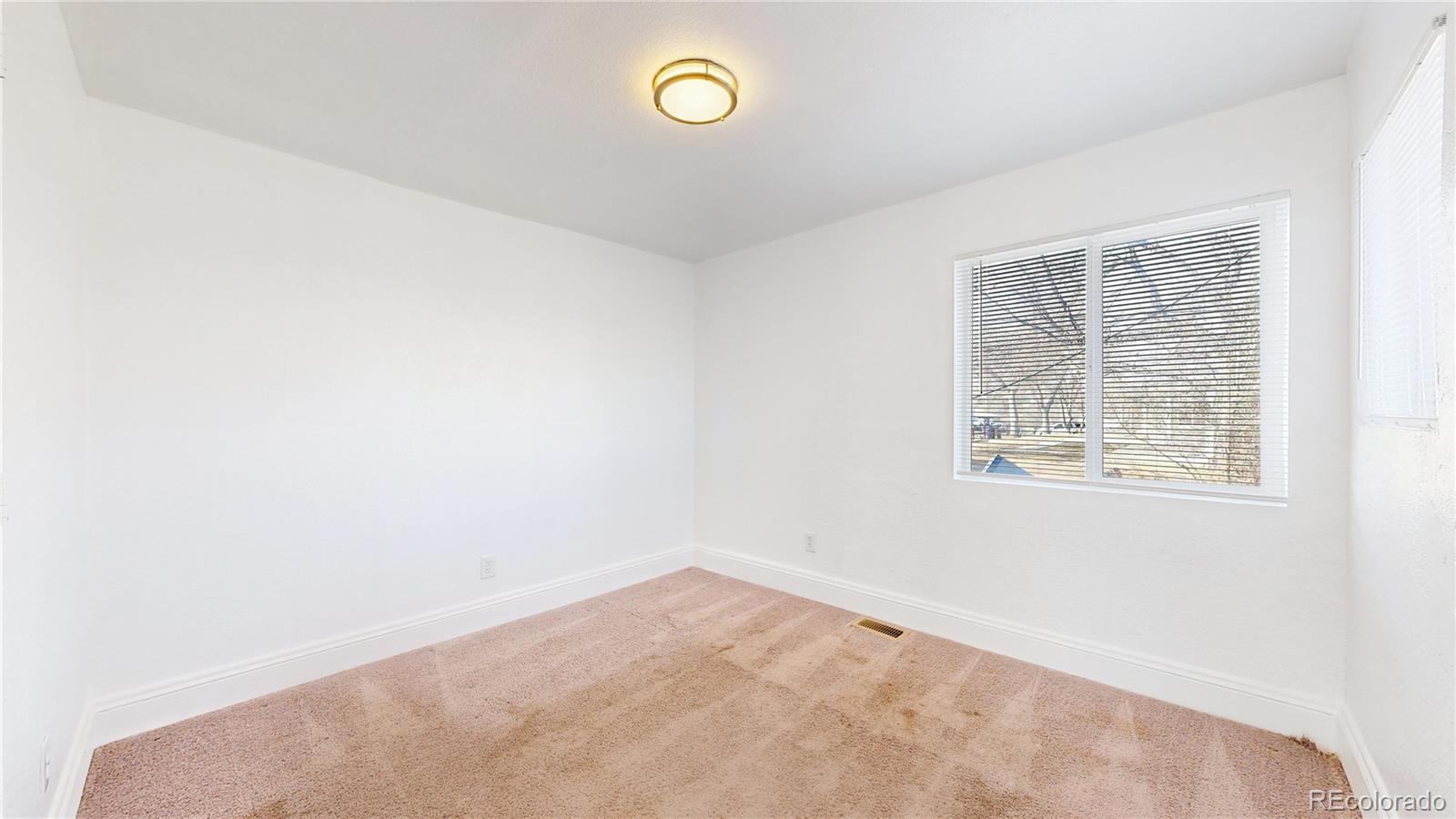 345 South Utica Street Denver, CO 80219 - Photo 15 of 19 an empty room with a window