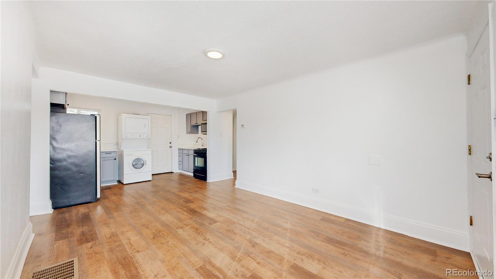 345 South Utica Street Denver, CO 80219 - Photo 3 of 19 a view of empty room with wooden floor