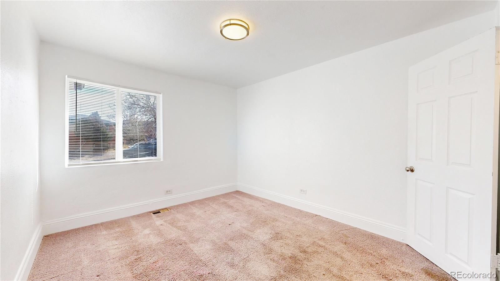 345 South Utica Street Denver, CO 80219 - Photo 9 of 19 an empty room with a window