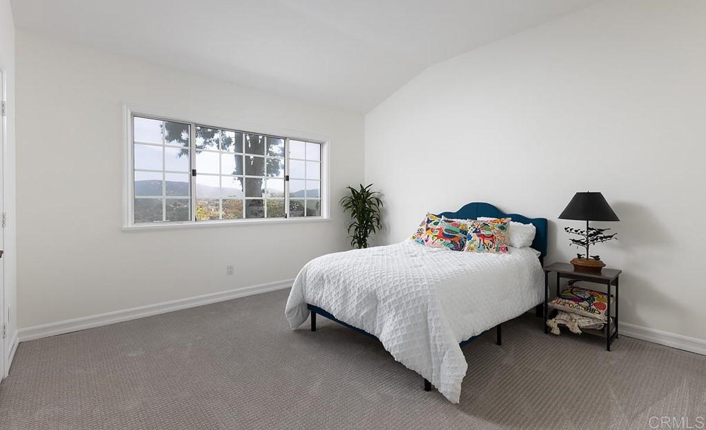 6949 Elfin Oaks Road Escondido, CA 92029 - Photo 13 of 24 a bedroom with a bed and window