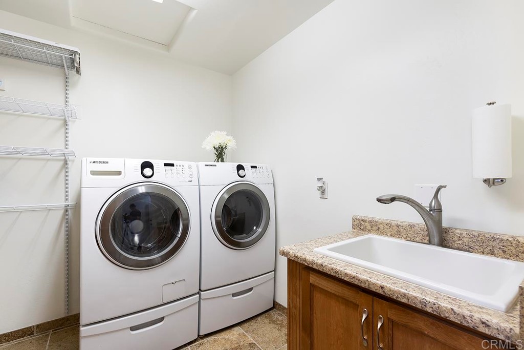 6949 Elfin Oaks Road Escondido, CA 92029 - Photo 16 of 24 a utility room with sink dryer and washer