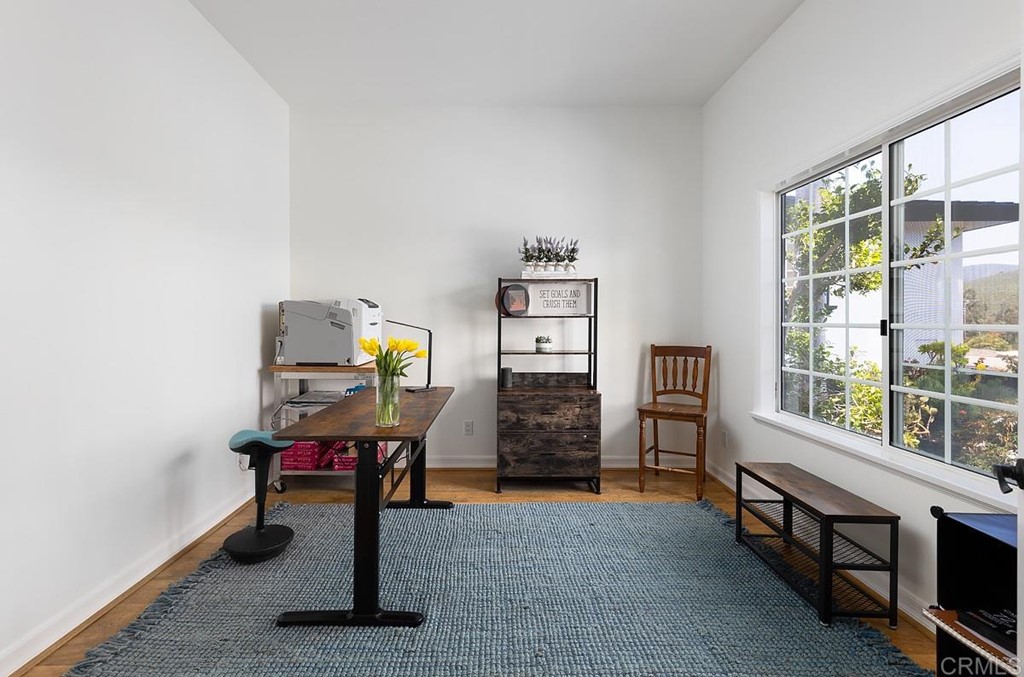 6949 Elfin Oaks Road Escondido, CA 92029 - Photo 17 of 24 a view of a workspace with furniture and a window