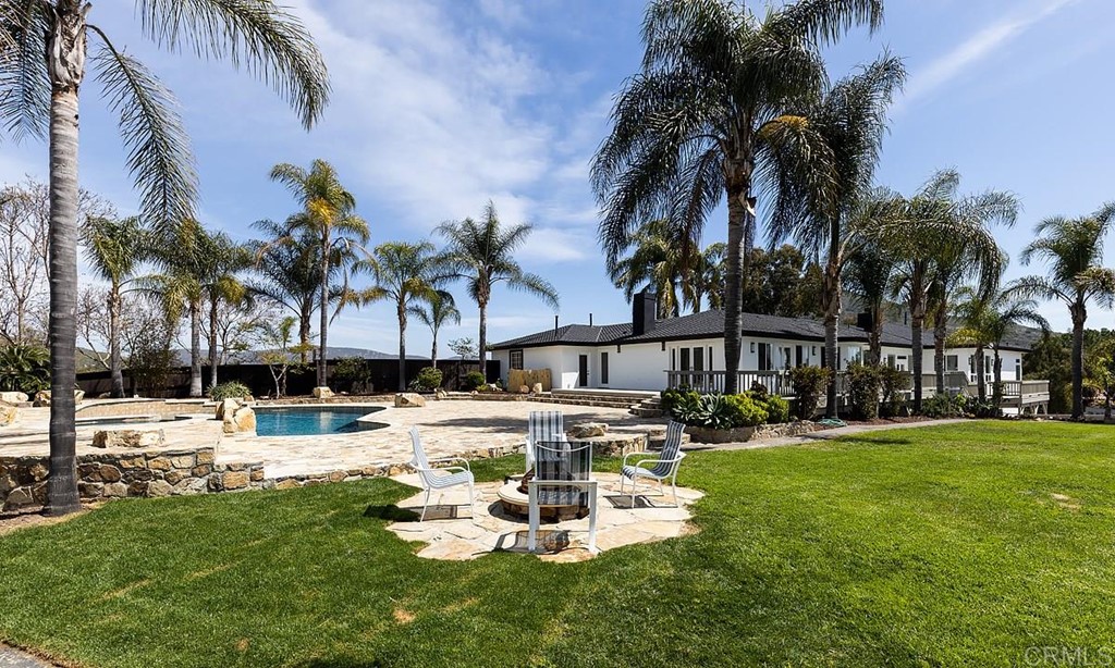 6949 Elfin Oaks Road Escondido, CA 92029 - Photo 20 of 24 a view of a swimming pool with a table and chairs